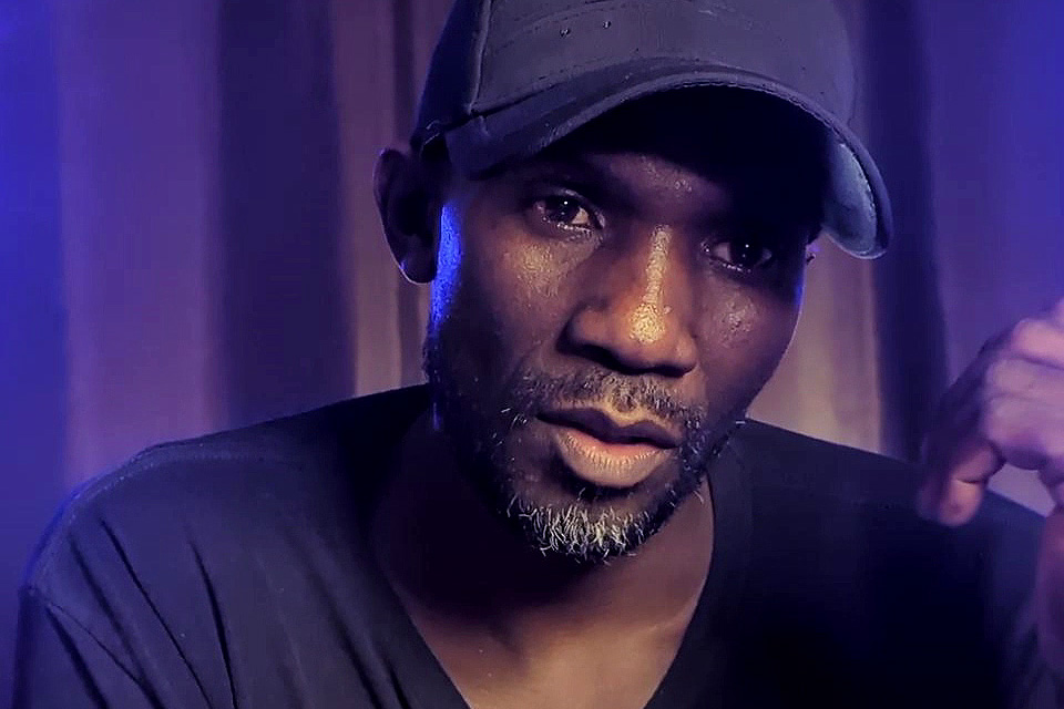 Meshack in a relaxed cap, speaking candidly.